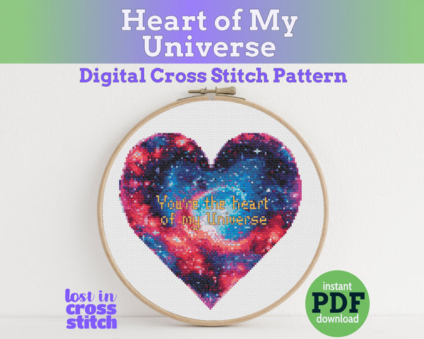 Cross stitch pattern with a heart design and text 'Heart of My Universe' in an embroidery hoop.