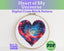 Cross stitch pattern with a heart design and text 'Heart of My Universe' in an embroidery hoop.
